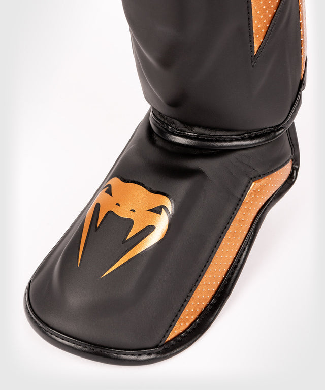 Protège-tibias Venum Elite Evo – Noir/Bronze
