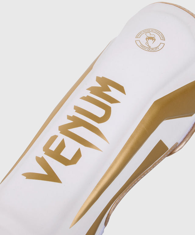 Protège-tibias Venum Elite – Blanc/Or
